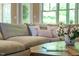 Comfortable living room features neutral tones, large windows, and a cozy sectional sofa with decorative pillows at 113 Ruskin Dr, Chapel Hill, NC 27516