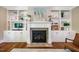 Beautiful living room features custom built-in shelving, a fireplace, and hardwood flooring at 113 Ruskin Dr, Chapel Hill, NC 27516