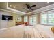 Bright main bedroom with balcony access, a TV, sitting area, and neutral tones at 113 Ruskin Dr, Chapel Hill, NC 27516