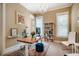 Stylish home office with a modern desk, plush rug, chandelier, and abundant natural light at 113 Ruskin Dr, Chapel Hill, NC 27516