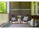 Inviting porch with cozy seating and privacy screens to enjoy the outdoor view at 113 Ruskin Dr, Chapel Hill, NC 27516
