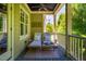 Covered porch with comfortable lounge chairs perfect for relaxation and enjoying the views at 113 Ruskin Dr, Chapel Hill, NC 27516