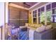 Relaxing screened porch with comfortable seating, outdoor decor, and views of the lush greenery at 113 Ruskin Dr, Chapel Hill, NC 27516