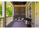 Relaxing covered porch with seating, privacy screen, and charming decor at 113 Ruskin Dr, Chapel Hill, NC 27516