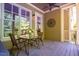 Cozy porch area featuring a table, chairs, and natural light filtering through the windows at 113 Ruskin Dr, Chapel Hill, NC 27516