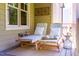Inviting covered porch featuring two comfortable lounge chairs with accent tables on a decorative outdoor rug at 113 Ruskin Dr, Chapel Hill, NC 27516