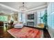 Inviting sitting area boasts natural light, stylish chandelier, and comfortable seating with a colorful rug at 113 Ruskin Dr, Chapel Hill, NC 27516