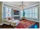 Cozy sitting area features a decorative chandelier, white shutters, and a vibrant area rug at 113 Ruskin Dr, Chapel Hill, NC 27516
