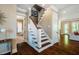 Open staircase with dark wood treads and white risers, leading to the upper level at 113 Ruskin Dr, Chapel Hill, NC 27516