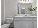 Bright bathroom featuring white cabinets, a large mirror, and a toilet at 115 N Chubb Rdg, Wilson's Mills, NC 27520