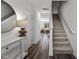 Bright entryway with wood floors, stairs, modern console table and view to dining area at 115 N Chubb Rdg, Wilson's Mills, NC 27520