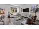 Inviting living room featuring stylish seating, a modern entertainment unit, and large windows with scenic views at 115 N Chubb Rdg, Wilson's Mills, NC 27520