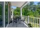 Cozy balcony with seating provides an outdoor retreat with lush treetop views at 11549 Helmond Way # 107, Raleigh, NC 27617
