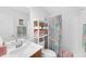 Bright bathroom featuring a patterned shower curtain, open shelving, and a functional vanity area at 11549 Helmond Way # 107, Raleigh, NC 27617