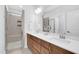 Modern bathroom with double vanity, quartz counters, sleek cabinetry, and tiled glass enclosed shower at 11549 Helmond Way # 107, Raleigh, NC 27617