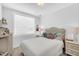 Comfortable bedroom with tufted headboard, white bedding, and coordinated nightstands offering a cozy retreat at 11549 Helmond Way # 107, Raleigh, NC 27617