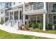 Charming multi-story condo with brick facade, two balconies, and manicured garden for inviting curb appeal at 11549 Helmond Way # 107, Raleigh, NC 27617