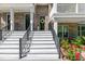 Welcoming front entrance with white stairs, black railings, and a charming brick facade at 11549 Helmond Way # 107, Raleigh, NC 27617
