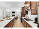 Stylish kitchen featuring sleek appliances, modern cabinetry, and a seamless flow into the living area at 11549 Helmond Way # 107, Raleigh, NC 27617