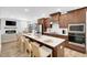 Modern kitchen with stainless steel appliances, a large island with seating, and open to living area at 11549 Helmond Way # 107, Raleigh, NC 27617