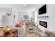 Bright and inviting living room with a cozy fireplace and comfortable seating arrangement at 11549 Helmond Way # 107, Raleigh, NC 27617