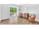 Bright living room featuring hardwood floors, access to a balcony, and stylish decor at 11549 Helmond Way # 107, Raleigh, NC 27617