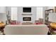 Well-lit living room boasting a modern fireplace, comfortable sofa, and stylish decor accents at 11549 Helmond Way # 107, Raleigh, NC 27617