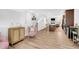 Open-concept living space with hardwood floors, neutral tones, and a view into the kitchen at 11549 Helmond Way # 107, Raleigh, NC 27617