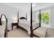 Spacious bedroom featuring a four poster bed, balcony, and neutral decor providing a relaxing retreat at 11549 Helmond Way # 107, Raleigh, NC 27617