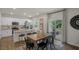 Bright dining area with wood floors, seating for six, and sliding door access to a deck at 1209 Pavo Path, Wendell, NC 27591