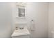 Bright bathroom featuring a white vanity, mirror, and towel rack against a neutral wall at 1223 Jamestown Ct, Cary, NC 27511