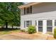 Charming townhouse exterior with light gray siding, black shutters and a well-maintained front yard at 1223 Jamestown Ct, Cary, NC 27511