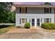 Exterior view of a well-maintained building with neutral siding, black shutters, and landscaping at 1223 Jamestown Ct, Cary, NC 27511