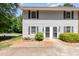 Charming townhouse exterior with light gray siding, black shutters and a well-maintained front yard at 1223 Jamestown Ct, Cary, NC 27511
