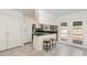 Clean kitchen with tiled floors, white cabinets, dark countertops, and stainless steel appliances at 1223 Jamestown Ct, Cary, NC 27511
