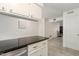View of the kitchen, showing granite counters and view into adjacent living area at 1223 Jamestown Ct, Cary, NC 27511