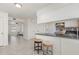 View of kitchen leading into the living room, with white cabinets and granite counters at 1223 Jamestown Ct, Cary, NC 27511