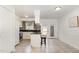 Clean kitchen with tiled floors, white cabinets, dark countertops, and stainless steel appliances at 1223 Jamestown Ct, Cary, NC 27511