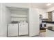 View of the kitchen with a laundry closet featuring a washer and dryer at 1223 Jamestown Ct, Cary, NC 27511
