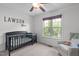 Bedroom room featuring a crib, ceiling fan, rocking chair and window with a backyard view at 124 Willa Chase Ct, Benson, NC 27504