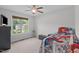 Bedroom featuring a ceiling fan, window with a view, and kid-friendly decor at 124 Willa Chase Ct, Benson, NC 27504