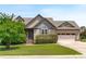 Charming home featuring a landscaped yard, attached garage, and inviting front entrance at 124 Willa Chase Ct, Benson, NC 27504