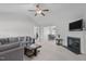 Bright living room featuring a fireplace, ceiling fan, and neutral carpet at 124 Willa Chase Ct, Benson, NC 27504