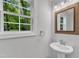 Bathroom featuring a new vanity, faucet, and framed mirror at 129 Davis St, Louisburg, NC 27549