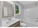 Updated bathroom featuring a new vanity, tub, and shower at 129 Davis St, Louisburg, NC 27549