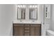 Modern bathroom featuring a double vanity with framed mirrors and a white countertop at 129 Davis St, Louisburg, NC 27549