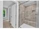 Bathroom with frameless glass shower door and decorative tile surround at 129 Davis St, Louisburg, NC 27549