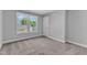 Bedroom featuring a large window with natural light and neutral carpeting at 129 Davis St, Louisburg, NC 27549