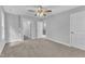 Spacious bedroom with neutral carpeting, ceiling fan and ensuite bathroom at 129 Davis St, Louisburg, NC 27549