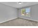 Well-lit bedroom with large window, fresh paint, and plush carpeting at 129 Davis St, Louisburg, NC 27549